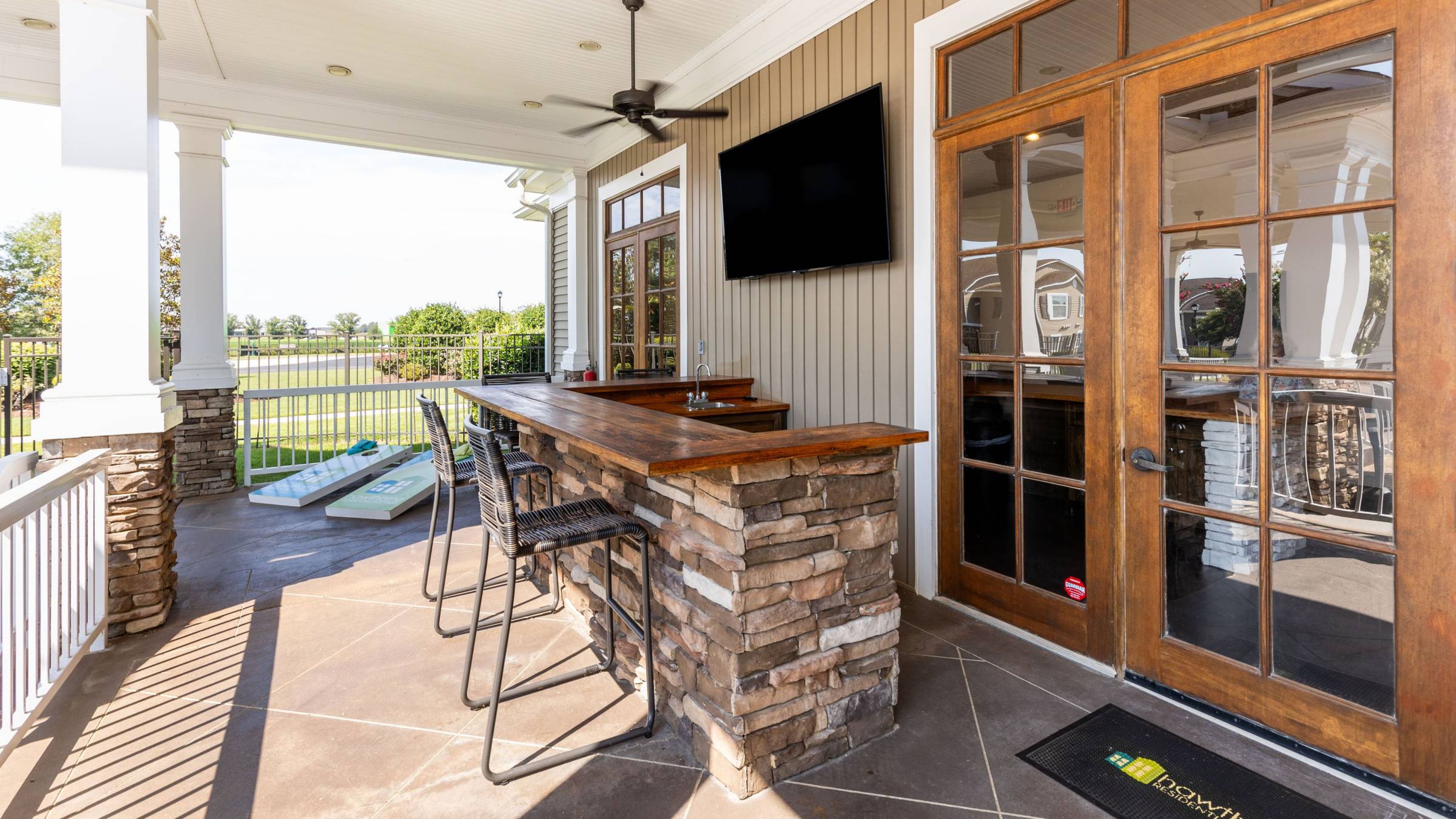 Hawthorne Crestview large outdoor porch area with entertainment bar and entry to leasing office